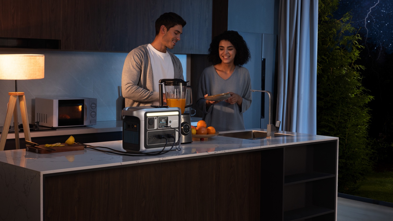 Couple using kitchen appliances powered by a portable station
