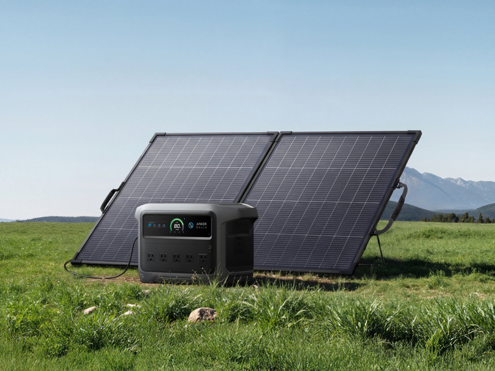 Power station charging from a folding solar panel in a meadow
