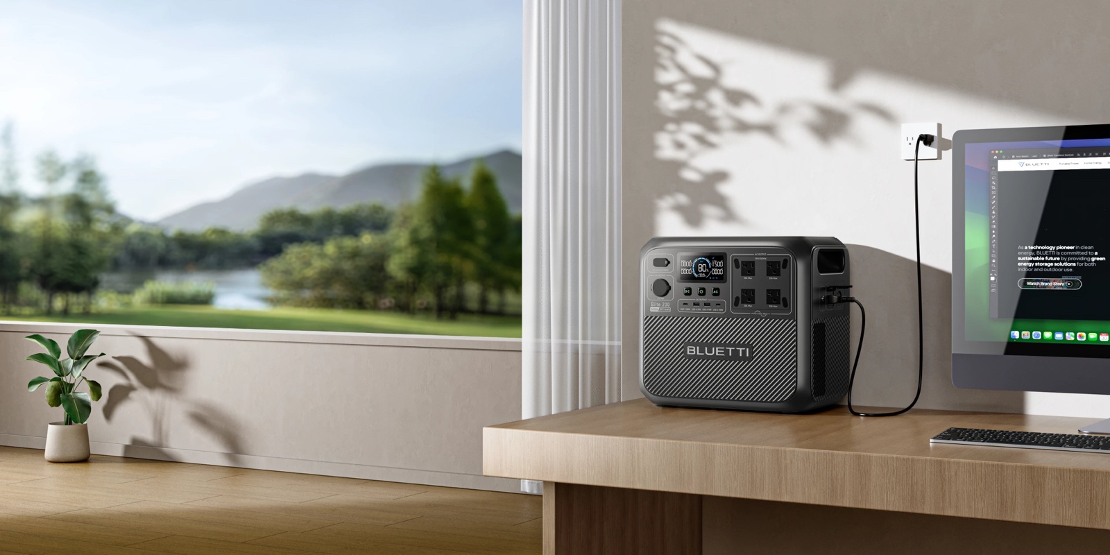 Power station powering a desktop computer beside a window