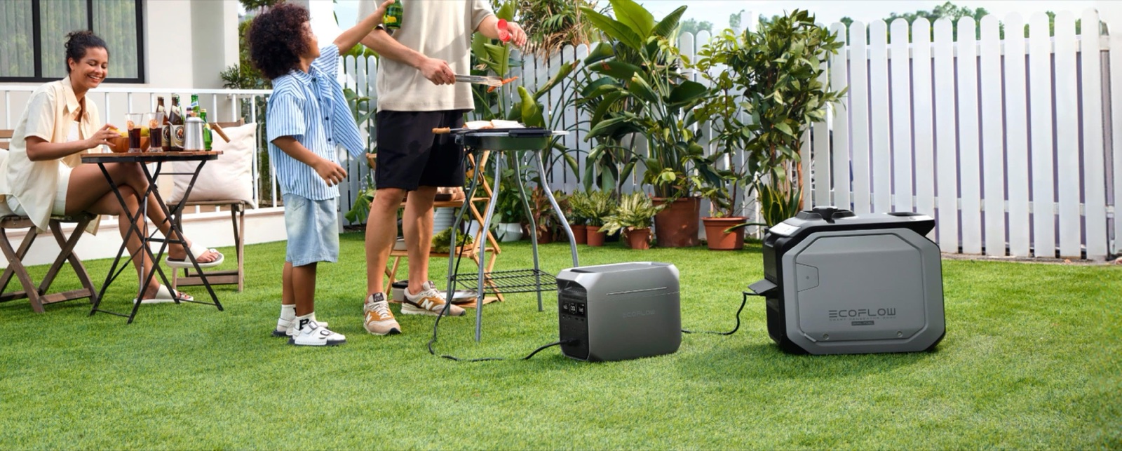 Family barbecue in a backyard with power stations on the lawn