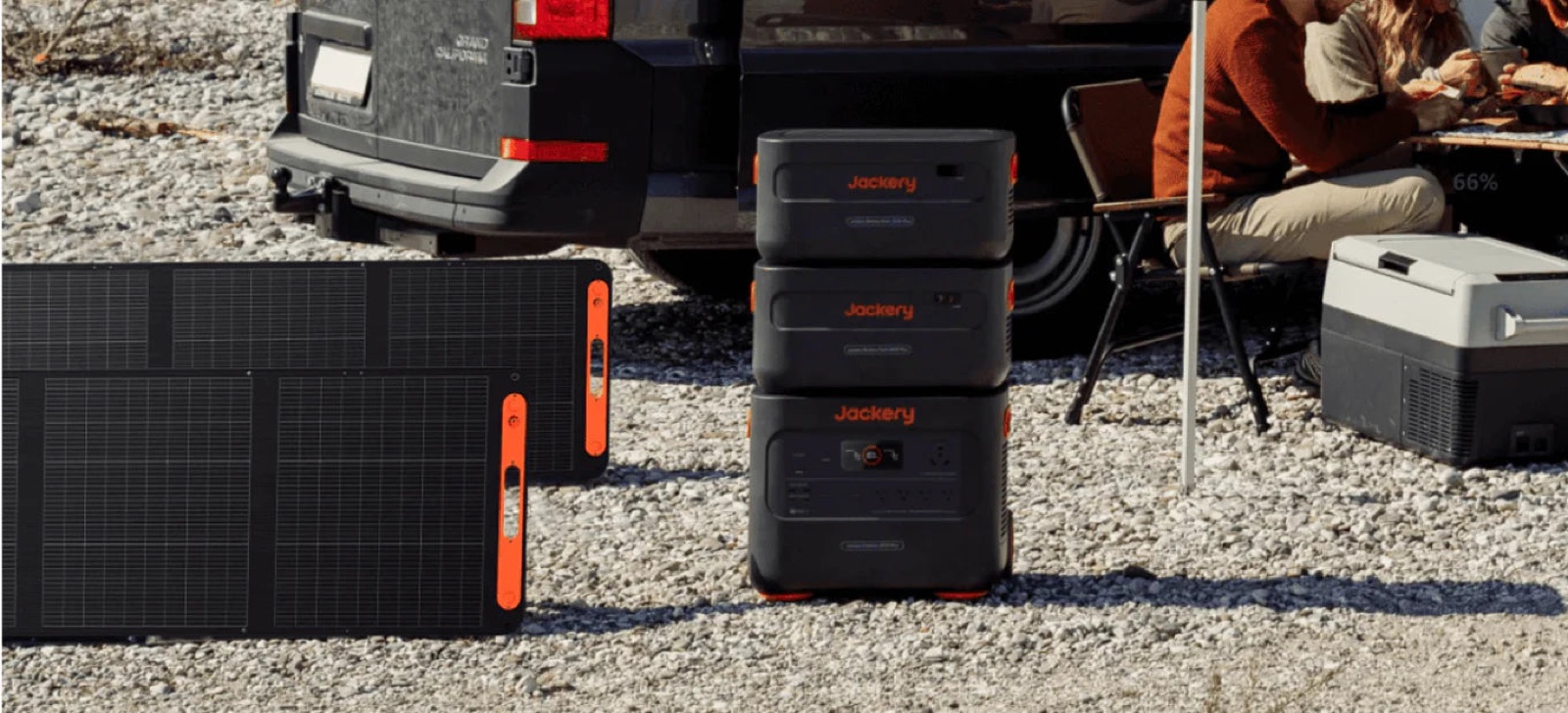 Stacked power stations and a solar panel at a gravel campsite