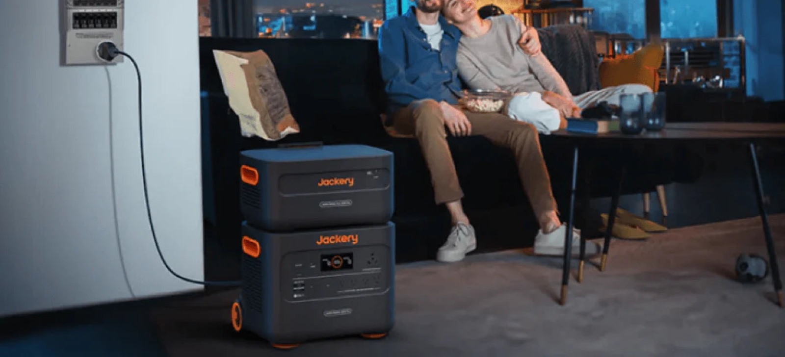 Stacked home batteries powering a living room in the evening