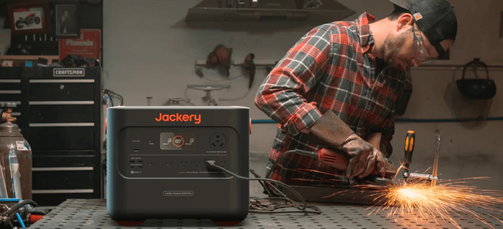 Welder working in a garage with a power station running